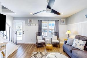 a living room with a blue couch and chairs at Bogue Banks Beauty - Unit A in Atlantic Beach