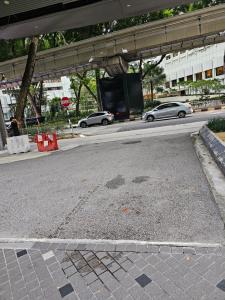 an empty street with cars driving down the road at Vortex suites klcc by Rahat in Kuala Lumpur