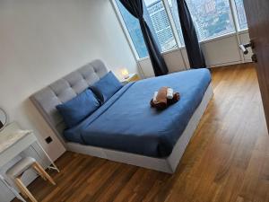 a bedroom with a bed with a stuffed animal on it at Vortex suites klcc by Rahat in Kuala Lumpur