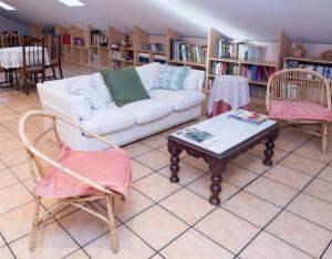 a living room with a couch and two chairs and a table at El Nogal De Nieva in Nieva