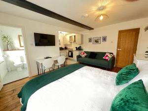 a bedroom with a large bed and a living room at The Boardroom in Hathern