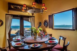 a dining room with a table with a view of the ocean at Casa de Vista Hermosa in Loreto