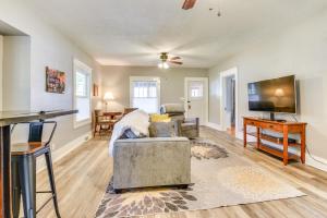 a living room with a couch and a flat screen tv at Cozy Anna Home Near Southern Illinois Attractions! in Anna