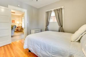 a bedroom with a large white bed and a table at Cozy Anna Home Near Southern Illinois Attractions! in Anna