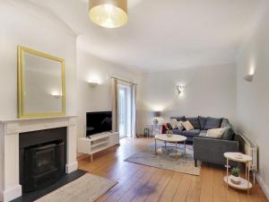 a living room with a couch and a fireplace at Spacious retreat in the heart of Tunbridge Wells Pass the Keys in Royal Tunbridge Wells