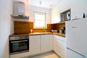 a kitchen with white cabinets and a sink and a window at Ferienhaus für 6 Personen ca 100 qm in Rakalj, Istrien Bucht von Raša in Rakalj