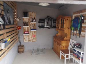 a room with a wall with a shelf and a table at Pauls Hexenhaus Wohnung Hexe mit Fahrrad Garage und Innenhof für Motorräder in Thale