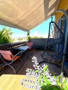 a balcony with a swing and a swing at Αfrodite! Roof top studio--Wonderful city view in Athens