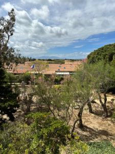 a view of a garden with trees and buildings at Appartement T2 tout équipé in Port Leucate