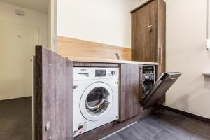 a laundry room with a washer and dryer at Zehnthof Apartment WH2 OG in Pulheim