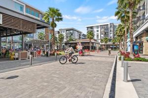 a person riding a bike down a street at Luxurious Urban Retreat with Amazing Amenities in Tampa