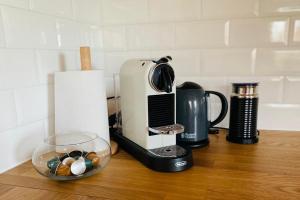 a kitchen counter with a coffee maker and a bowl of candy at Urlaub im Grünen - wunderschönes Bauernhaus in Bad Waltersdorf