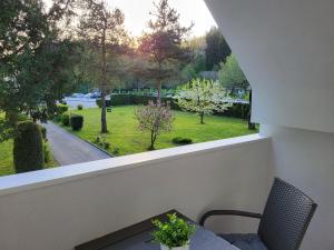 a balcony with a table and a view of a park at Apartma Jurka in Podčetrtek