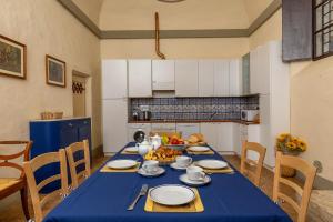 uma mesa com uma toalha de mesa azul na cozinha em Palazzo Costanti - A 8 minuti dalle terme em San Quirico dʼOrcia