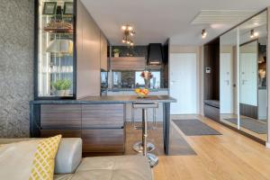 a kitchen with a island in the middle of a room at Prestige Views: Luxury Retreat in Bucharest +10 photos