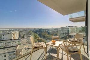 a balcony with chairs and a table and a view at Prestige Views: Luxury Retreat in Bucharest