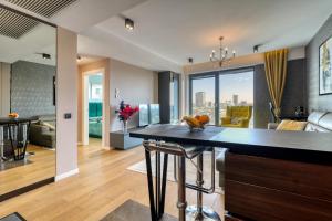 a kitchen and living room with a bar with a view at Prestige Views: Luxury Retreat in Bucharest