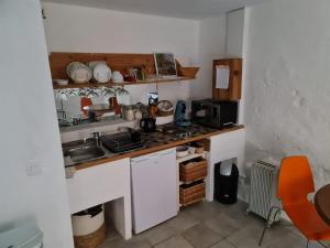 a small kitchen with a sink and a counter at Studio du pêcheur in Collioure