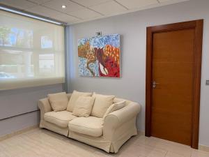 a living room with a couch and a painting at Home SEA&DREAMS Ifach in Calpe