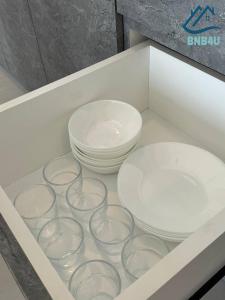 a drawer with several bowls and plates in it at Urban Suites @ George Town Penang by BNB4U in George Town
