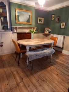 a dining room with a wooden table and chairs at Allington Hill-Bridport, Dorset in Bridport