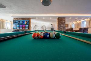 a billiard room with a pool table with balls at Gesamtes Ferienhaus in Buchenberg mit Grill, Garten und Terrasse in Buchenberg