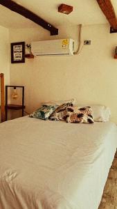 a bed in a bedroom with a white bedspread at Apartamento Pardo1945 TIPO INDUSTRIAL in Mompós