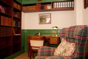 a room with a desk and a chair and a desk with a computer at Garvaregården Hotel , B&B och Café in Askersund