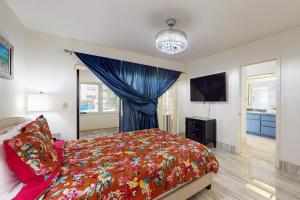 a bedroom with a bed and a television in it at Palms on the Canal in Cape Coral