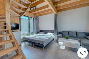 a living room with a bed and a couch at Nettes Ferienhaus in Pustkowo mit Eigener Terrasse in Pustkowo