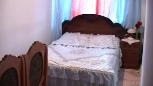 a bed with a wooden headboard in a bedroom at Anna Maria Hotel in Alaverdi