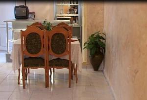 a dining room with a table with chairs and a tv at Anna Maria Hotel in Alaverdi