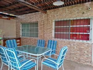 a patio with a table and blue chairs at Villawolf Casa para 5 personas in Federación