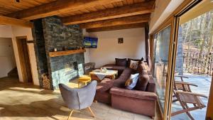 a living room with a couch and a fireplace at Chalet Robinson in Modra