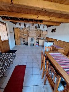 a large kitchen with wooden ceilings and a table and chairs at Chata u poľovníka 