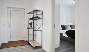 a bedroom with a bed and a black shelf at Appartement im Grünen, zentral in Biberach in Biberach an der Riß