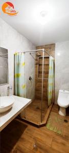 La salle de bains est pourvue d'une douche, d'un lavabo et de toilettes. dans l'établissement NatAle Residencial - Departamento Segundo Piso con cochera, à Tacna