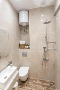 a bathroom with a sink and a toilet and a shower at Dimitra Central Apartments Chanioti in Hanioti