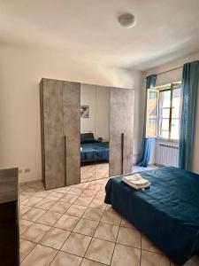 a bedroom with a bed and a large closet at Mary T House in Campagnano di Roma