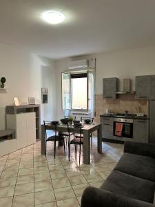a kitchen and living room with a table and chairs at Mary T House in Campagnano di Roma