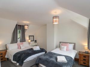 a bedroom with two beds and two lamps at Ramblers Cottage in Whitby