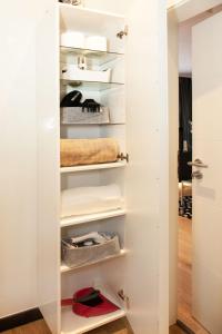 a closet with white walls and shelves at Little Oasis Near Frankfurt in Neulsenburg +32 photos
