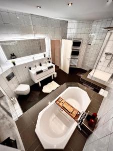 a bathroom with a toilet and a sink at Modern City Suites in Oberhausen