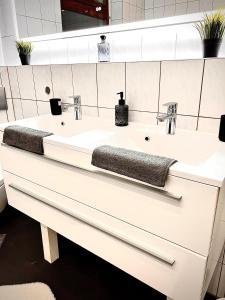 a bathroom with a white sink and a mirror at Modern City Suites in Oberhausen