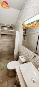 a bathroom with a white toilet and a sink at NatAle Residencial - Departamento Primer Piso con cochera in Tacna