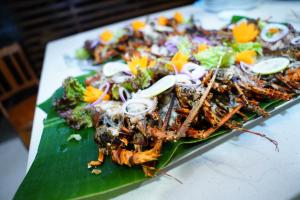 a plate of food on top of a banana leaf at VILLA BLUE LOTOUS in Gampaha