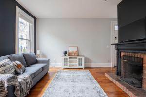 a living room with a couch and a fireplace at Kentucky Ave - Heart of Mainstrasse in Covington