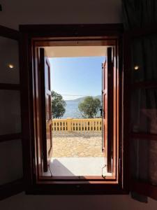 a window in a room with a view of the ocean at Caserma Regina in Gourna
