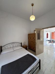a bedroom with a large bed and a dining room at Caserma Regina in Gourna
