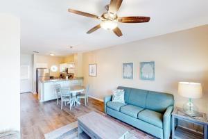 a living room with a couch and a ceiling fan at Coconut House in Duck Key
